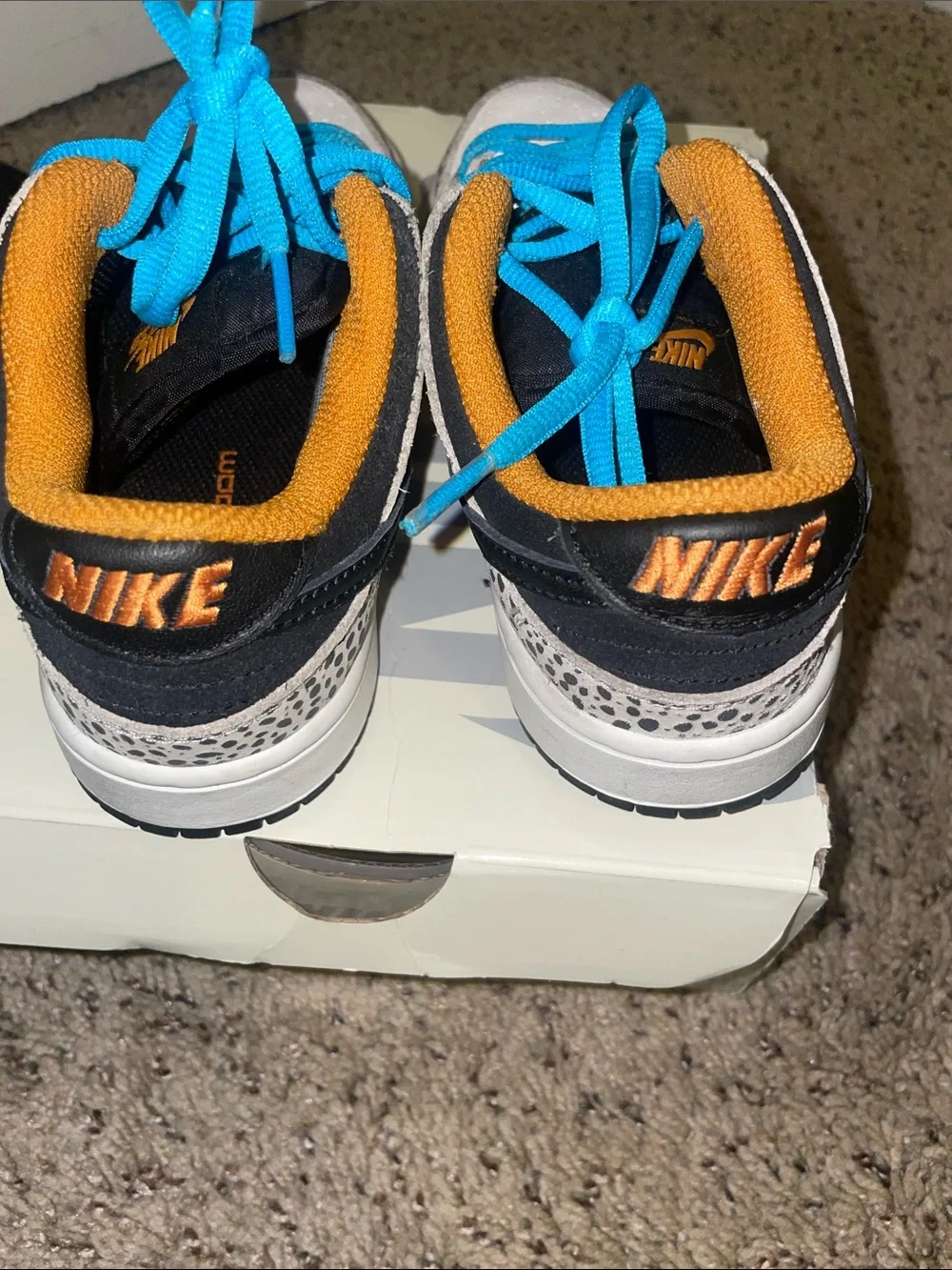 Nike Kids White Sneakers with Bright Blue Laces and Speckled Accents